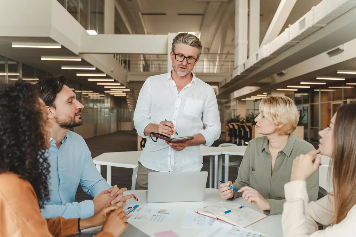 Project manager discussing the plan with the team at a table