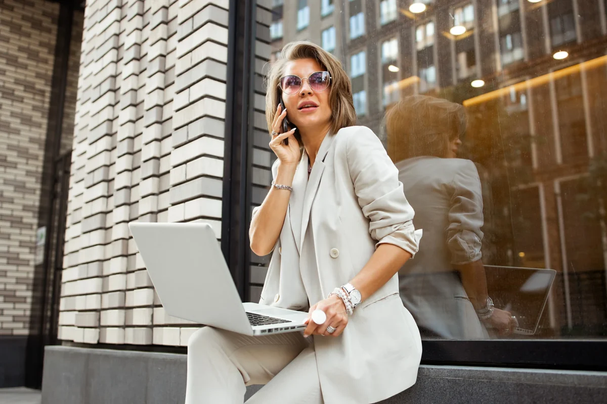 Woman with a laptop outside an office building
